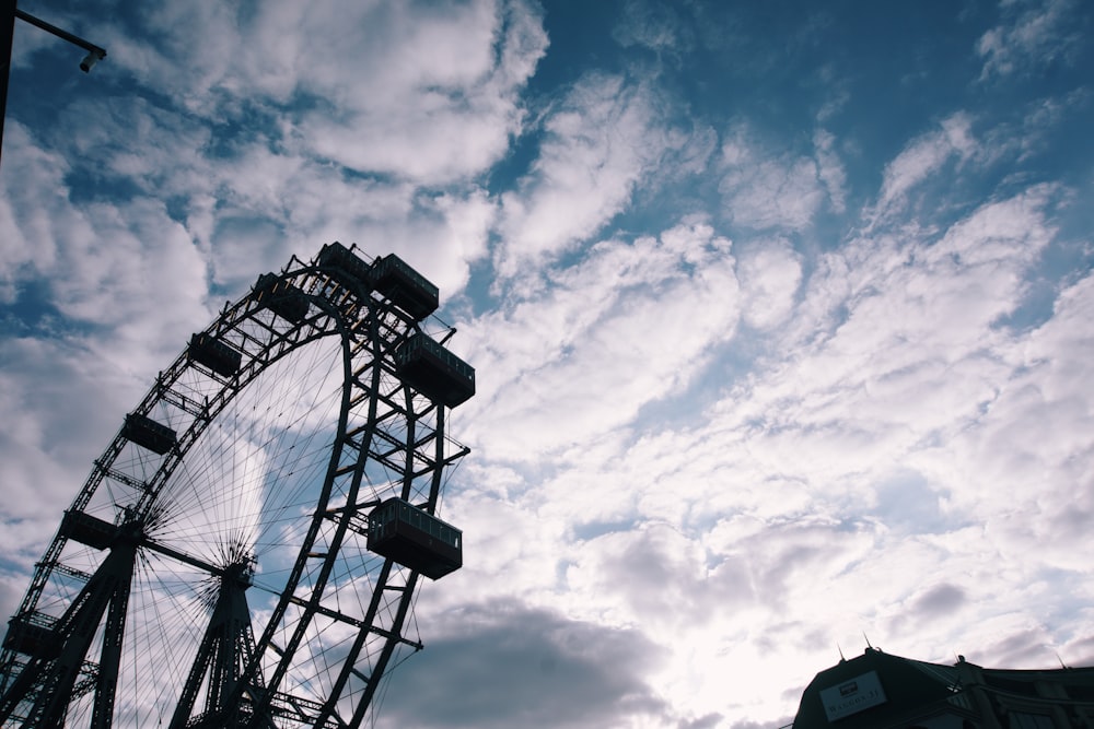 white ferris wheel under cloudy sky