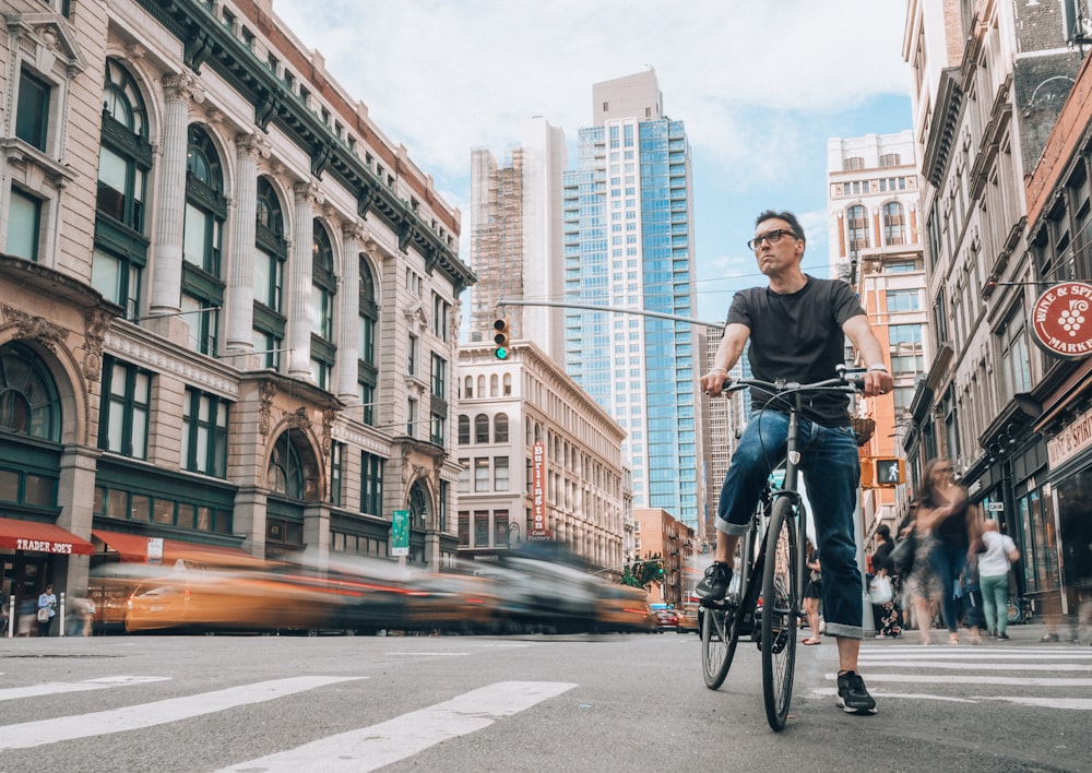 man riding bicycle on road