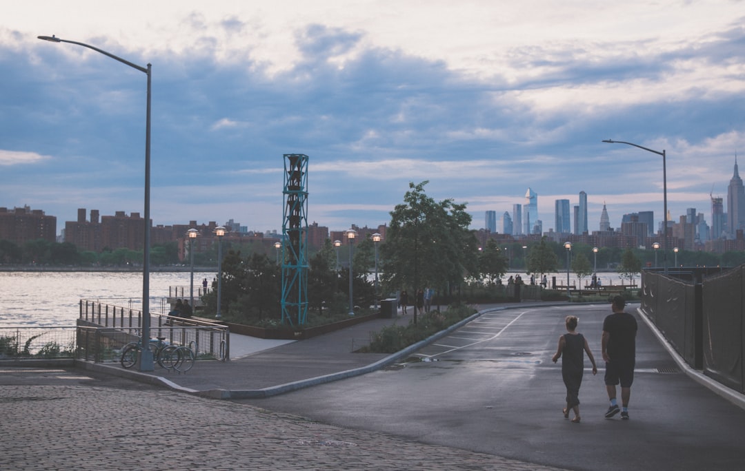 man and woman walking on empty road