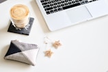 A cozy workspace with a laptop, coffee cup, and notes, capturing a blogger's daily routine.