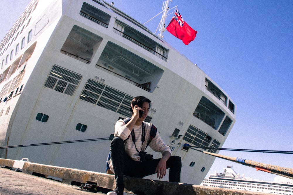 man sitting on ground near cruise