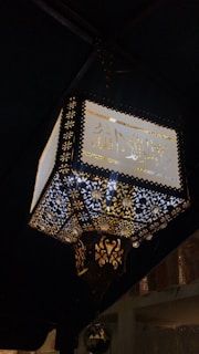 A beautifully decorated Ramadan lantern glowing softly on a wooden table