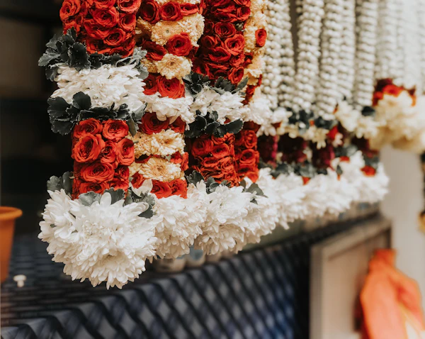 Fresh marigold and rose garlands strung for a ceremony