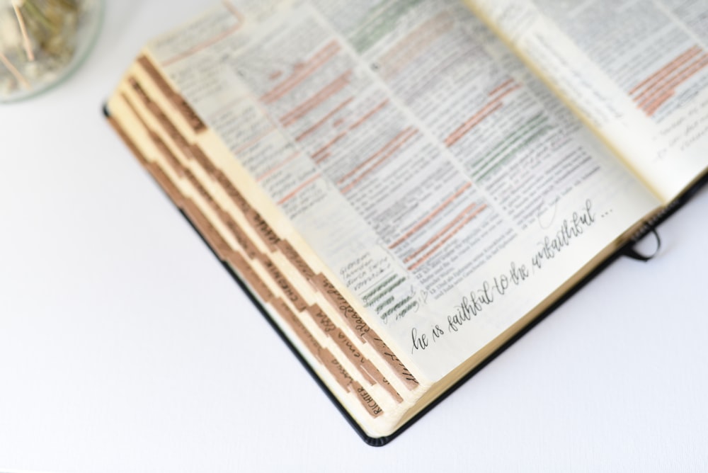 shallow focus photo of book on white surface