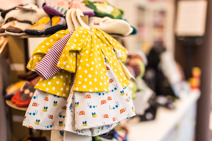 Baby clothing and little dresses hanging on a boutique rack.