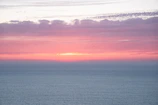Sunset hues blending into a calm sea horizon.
