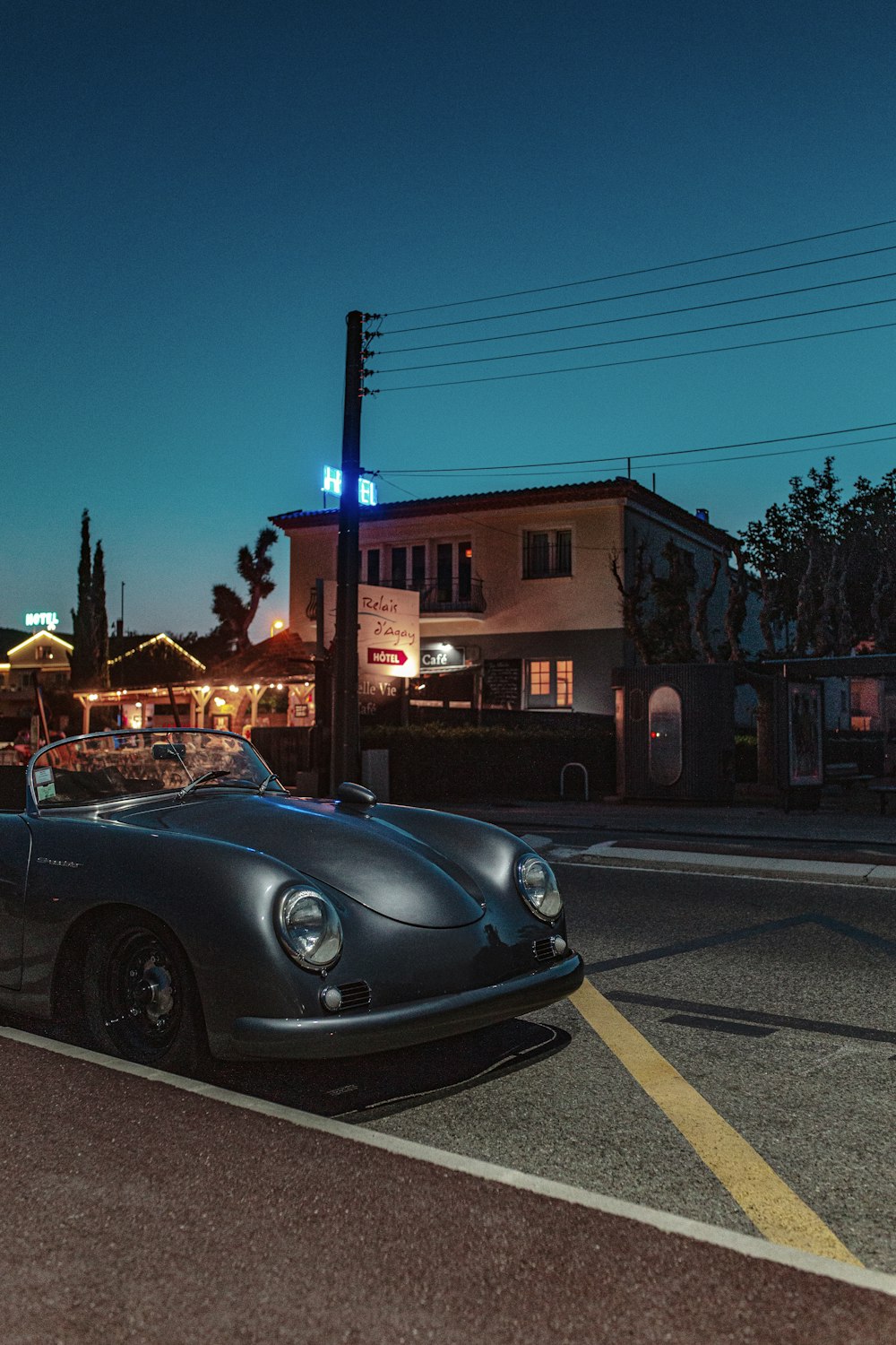 gray convertible Volkswagen beetle parked on side road