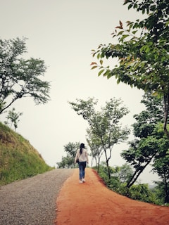 A person walking along a simple path in nature, reflecting on spiritual growth.