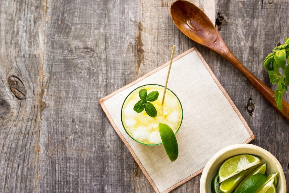 juice in cup on board beside wooden spoon