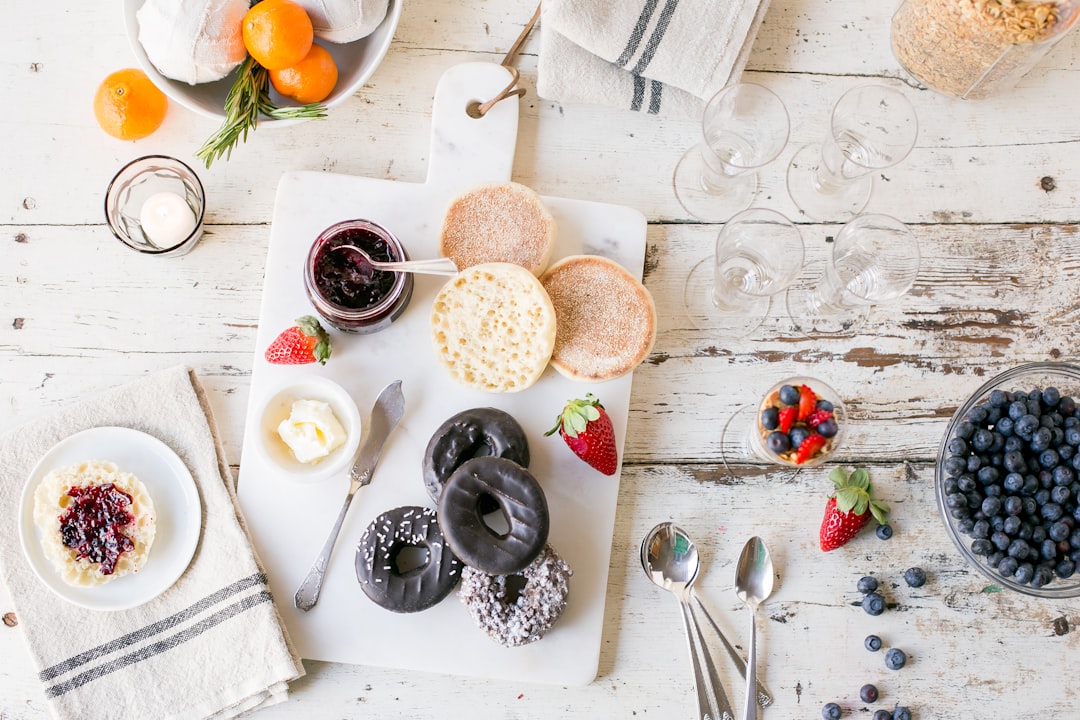 flat lay photography of breakfast with berries and doughnuts