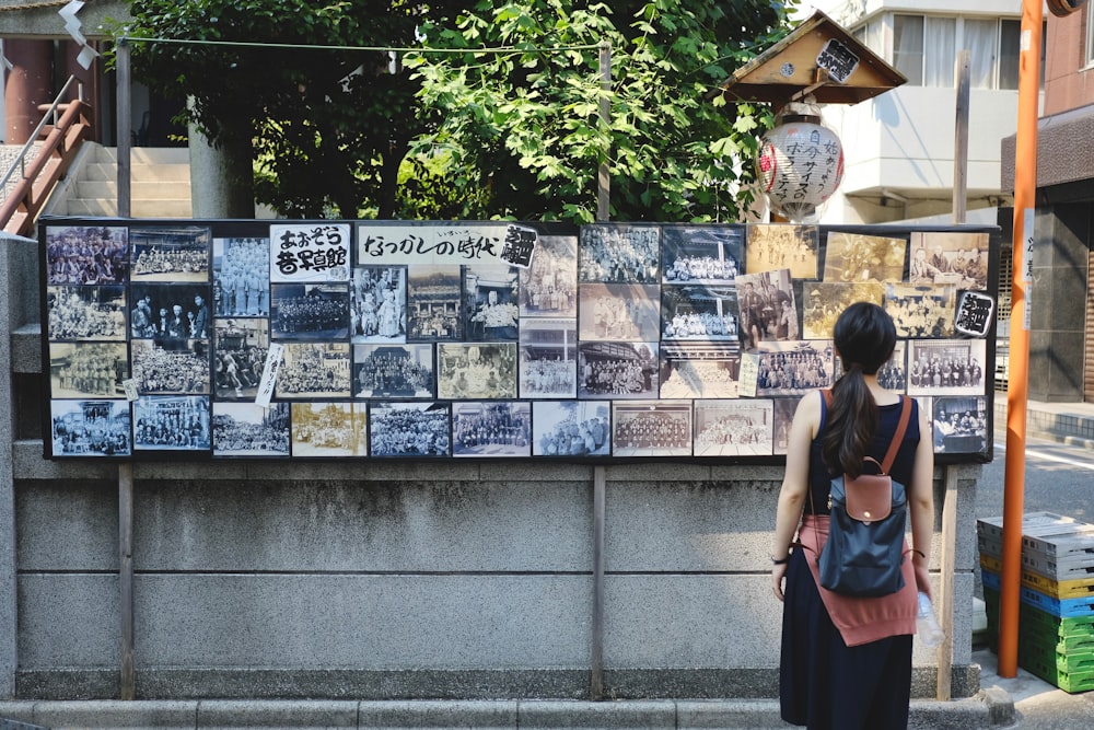 woman standing in front of paintings