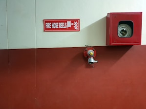 red metal fire hose reel container