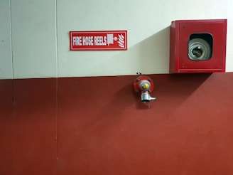 red metal fire hose reel container