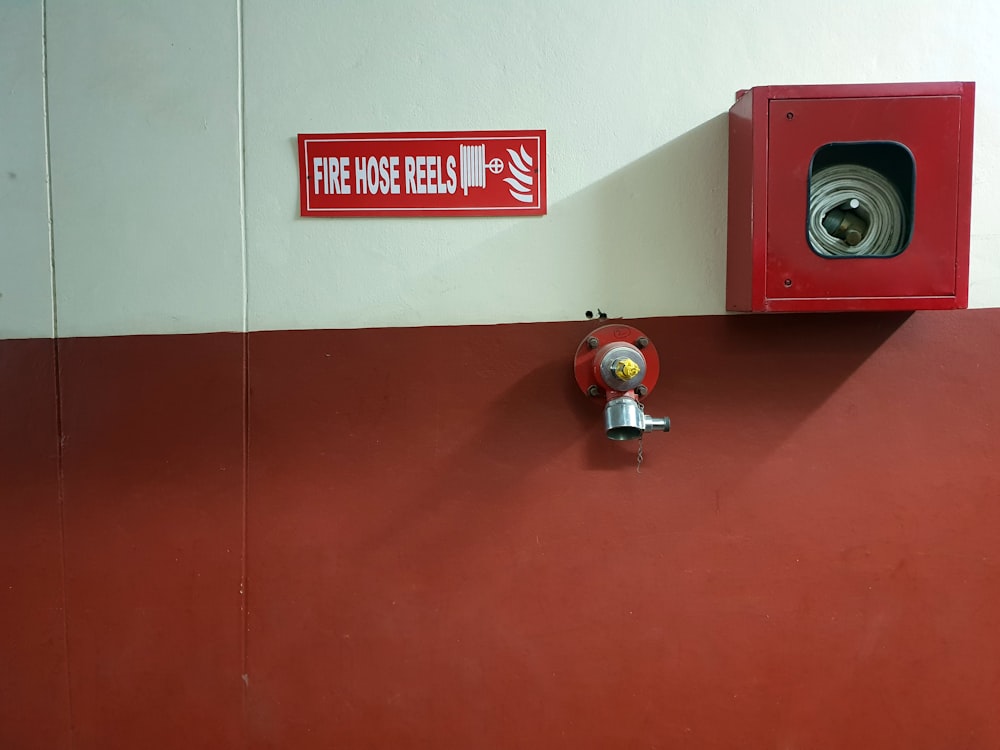 red metal fire hose reel container
