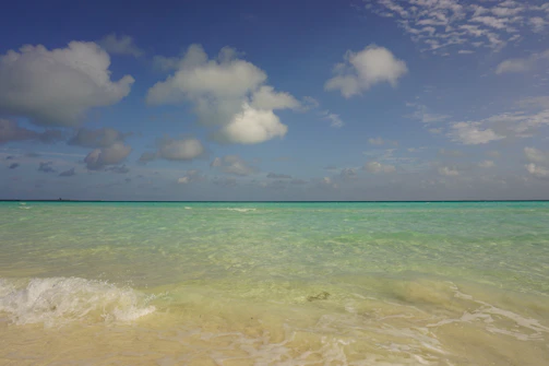 A serene beach in Da Nang with turquoise waves gently lapping the shore.