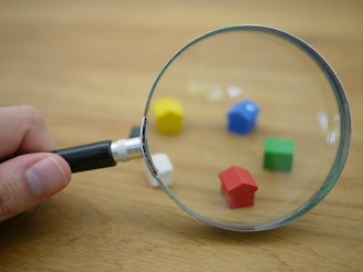 Close-up of hands inspecting finished plastic toys for quality assurance.