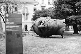 A large bronze sculpture displayed in an outdoor park setting.