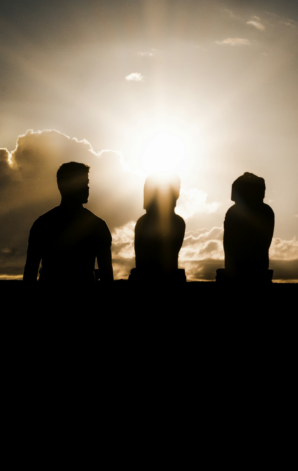 silhouette of three person during golden hour