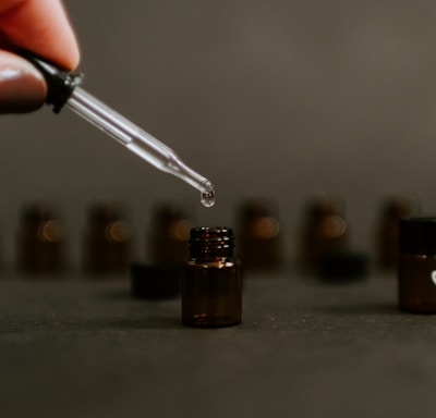 selective focus photography of brown tinted glass bottle