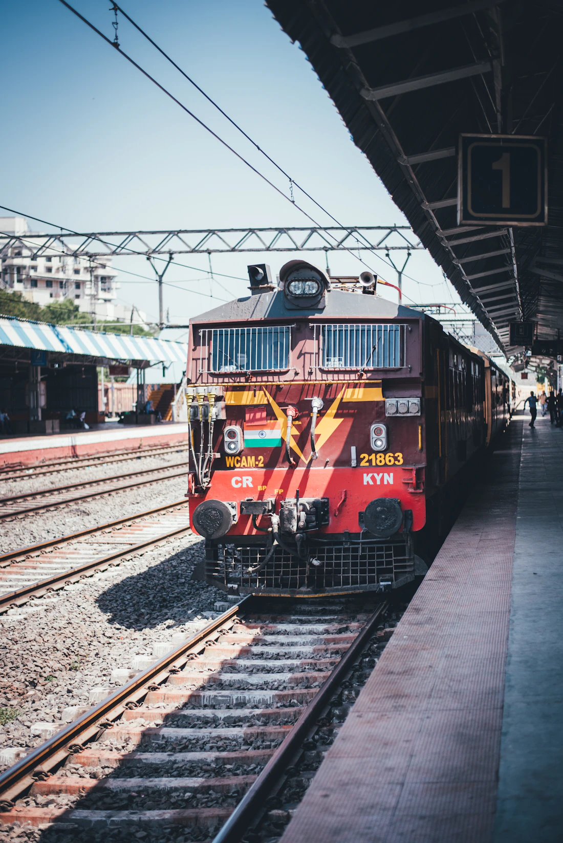 An Indian Railways express train at a busy station platform