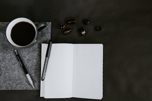 flat lay photo of coffee mug and pencils