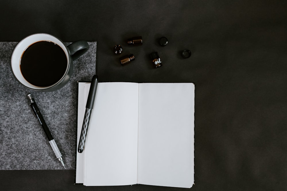 flat lay photo of coffee mug and pencils