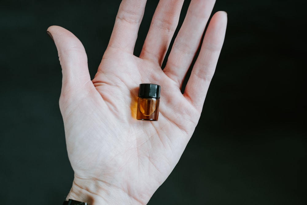 small brown and black glass bottle