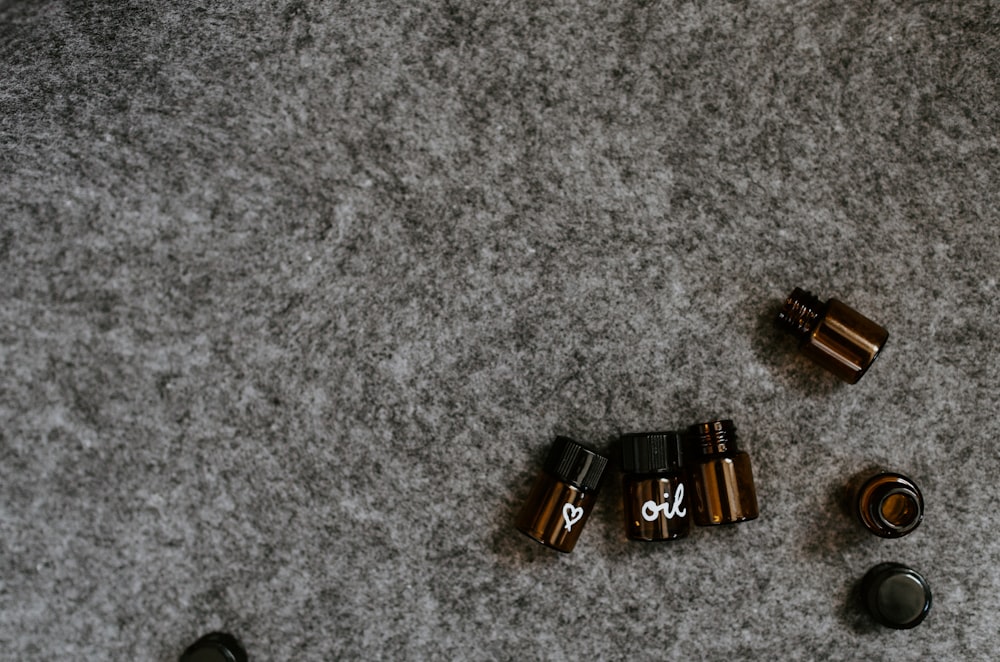 seven small bottle in a grey surface close-up photography