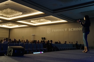 woman holding microphone standing on stage