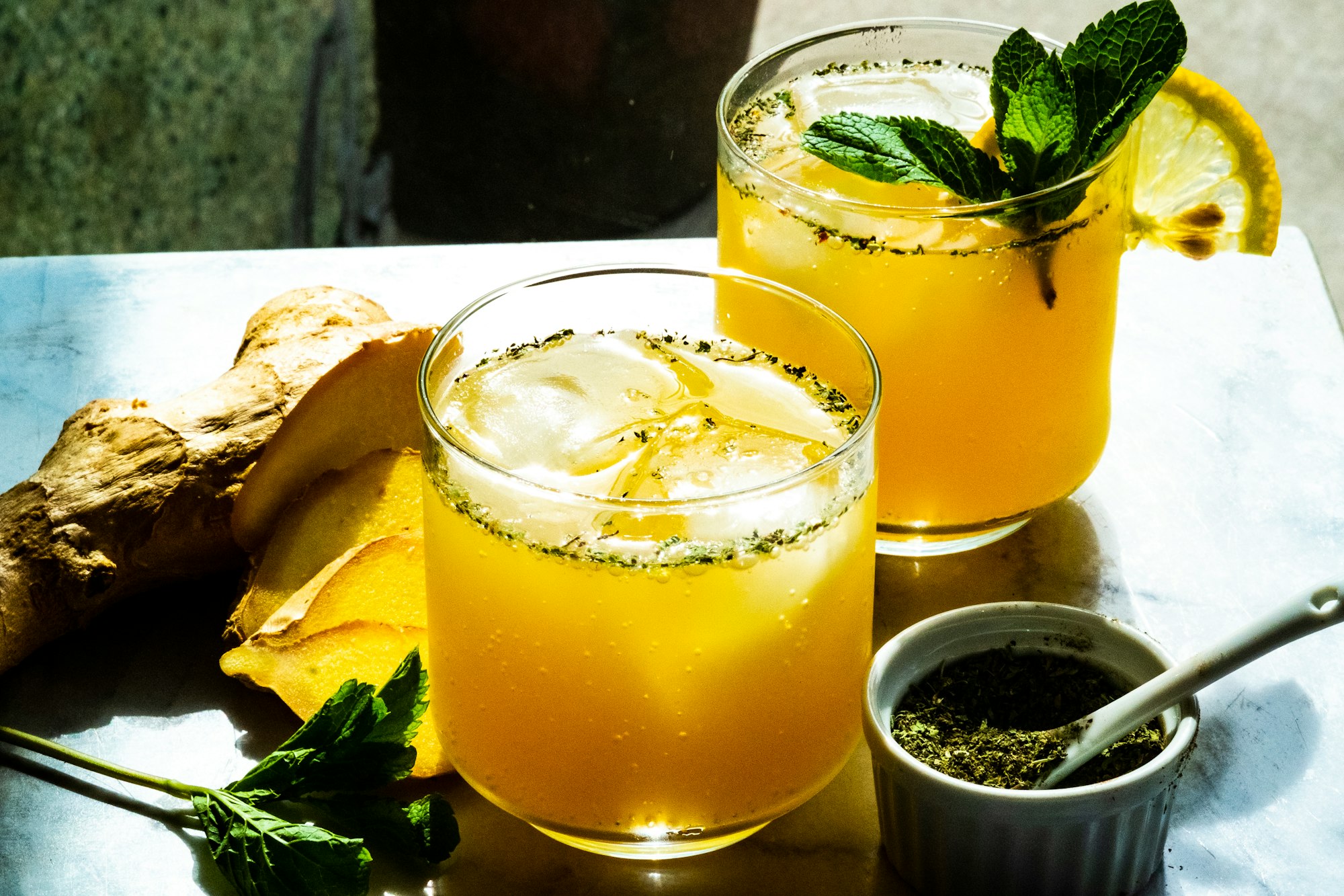 Lemon and lime juices with spices in a mocktail glass.
