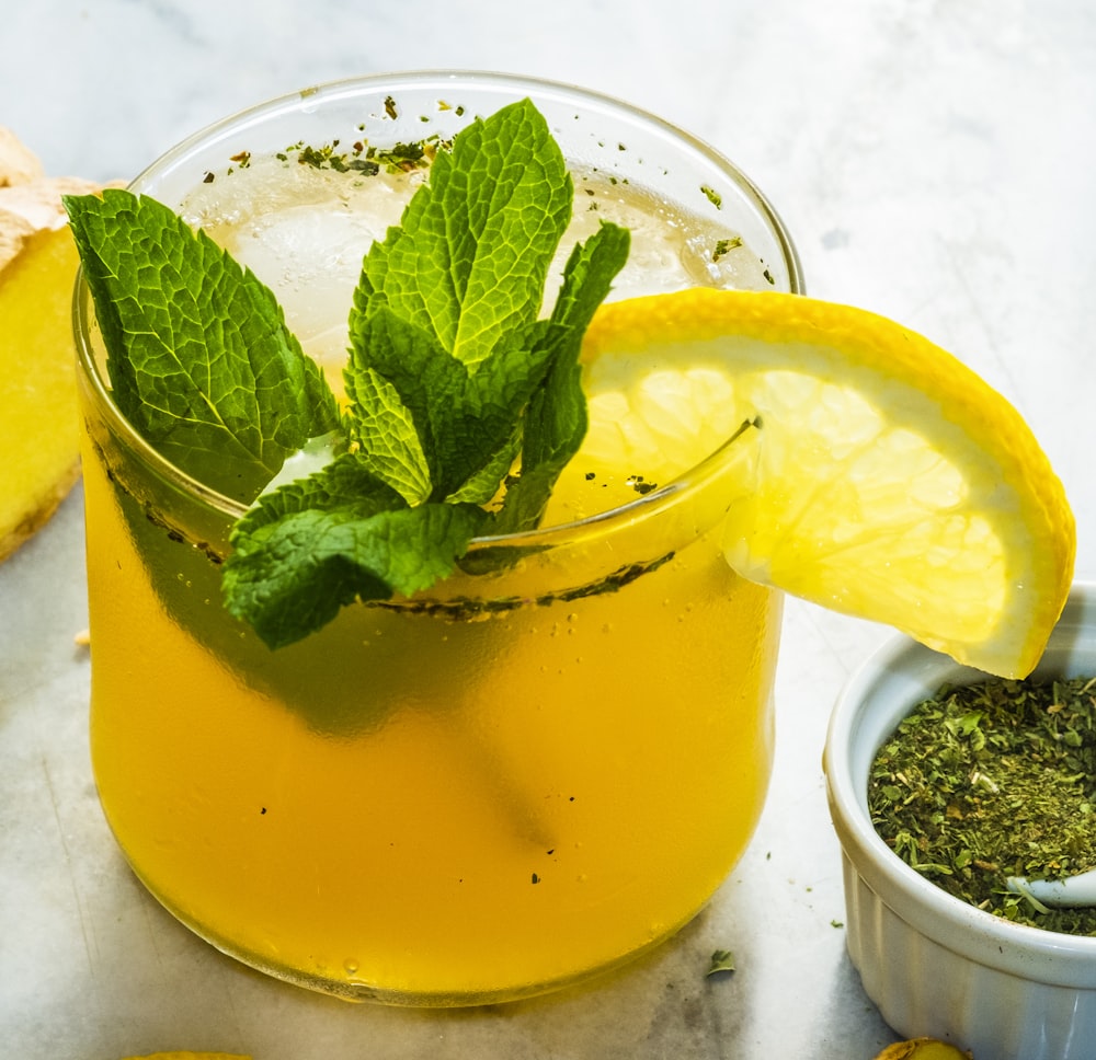 glass of lemon drink with slice of lemon