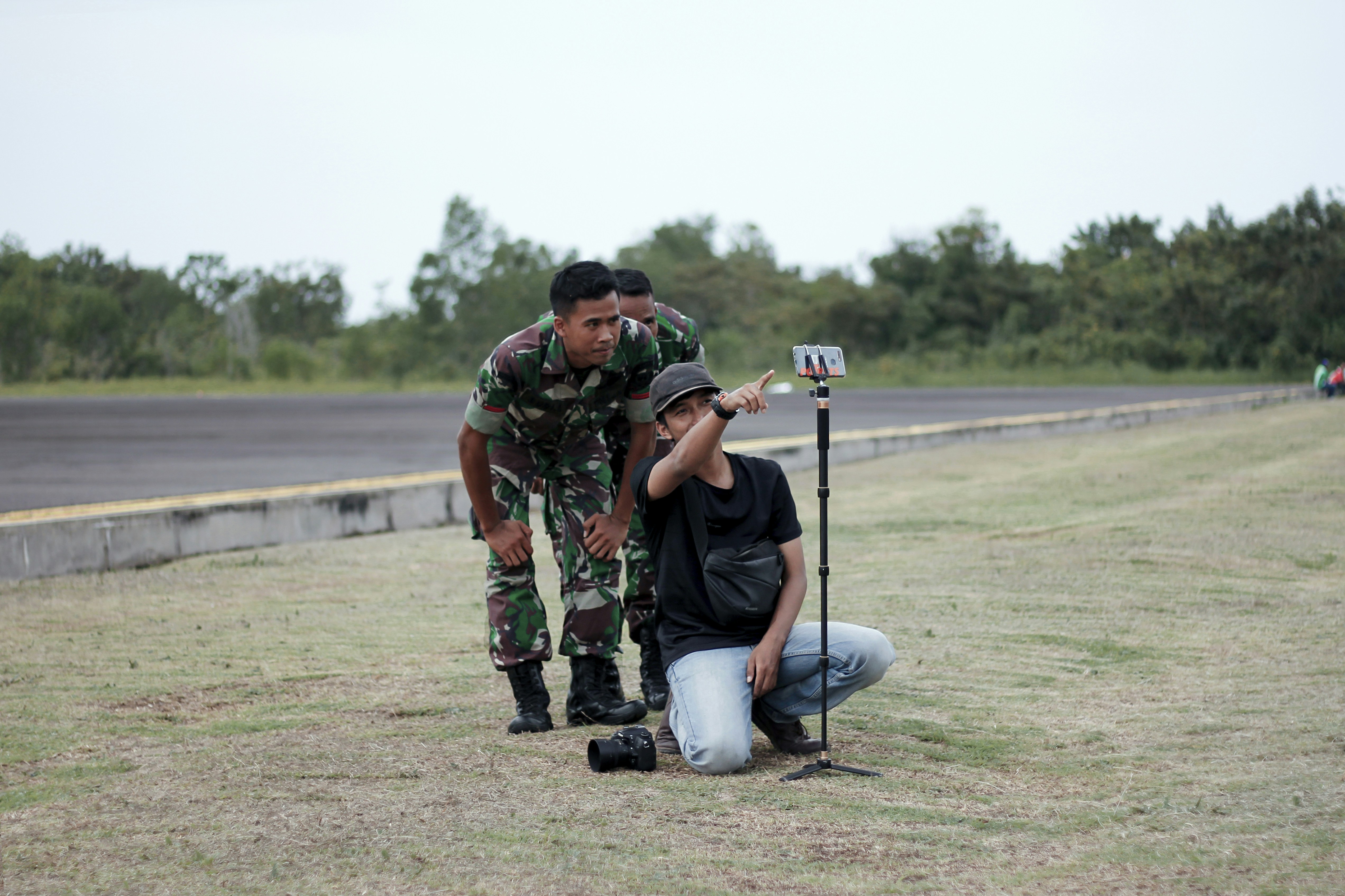 man standing beside soldier