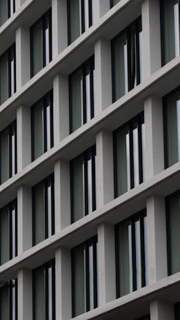 Close-up of modern building facade with clean architectural lines and glass windows.