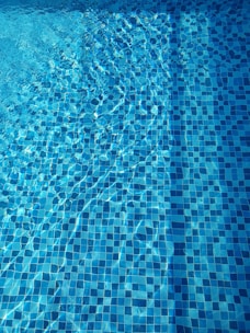 Close-up of clear blue water in a well-maintained swimming pool.