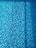 A close-up of a sparkling pool with a smooth, newly plastered surface and clear blue water.