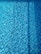 A close-up of a sparkling pool with a smooth, newly plastered surface and clear blue water.
