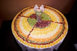 A beautifully arranged fruit cutting demonstration at an elegant event.