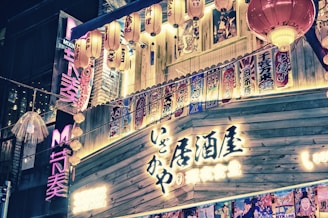 A vibrant street scene in Tokyo with colorful lanterns and bustling crowds at dusk.