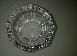 A simple round ashtray made of clear resin.