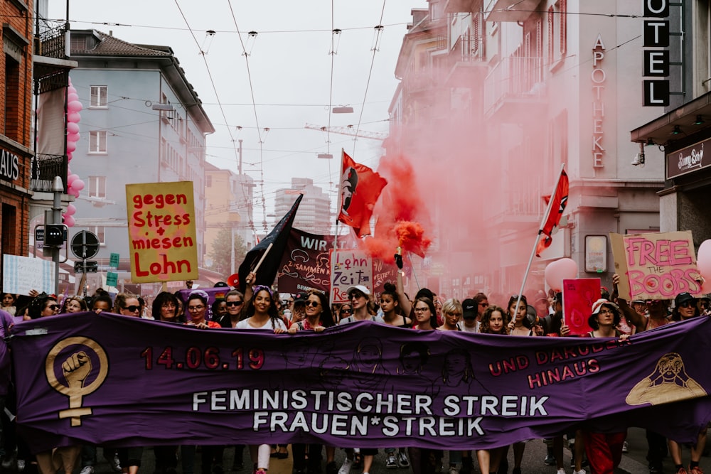 crowd holding purple banner