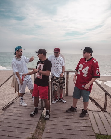 A group of men engaged in a lively discussion during an outdoor workshop.