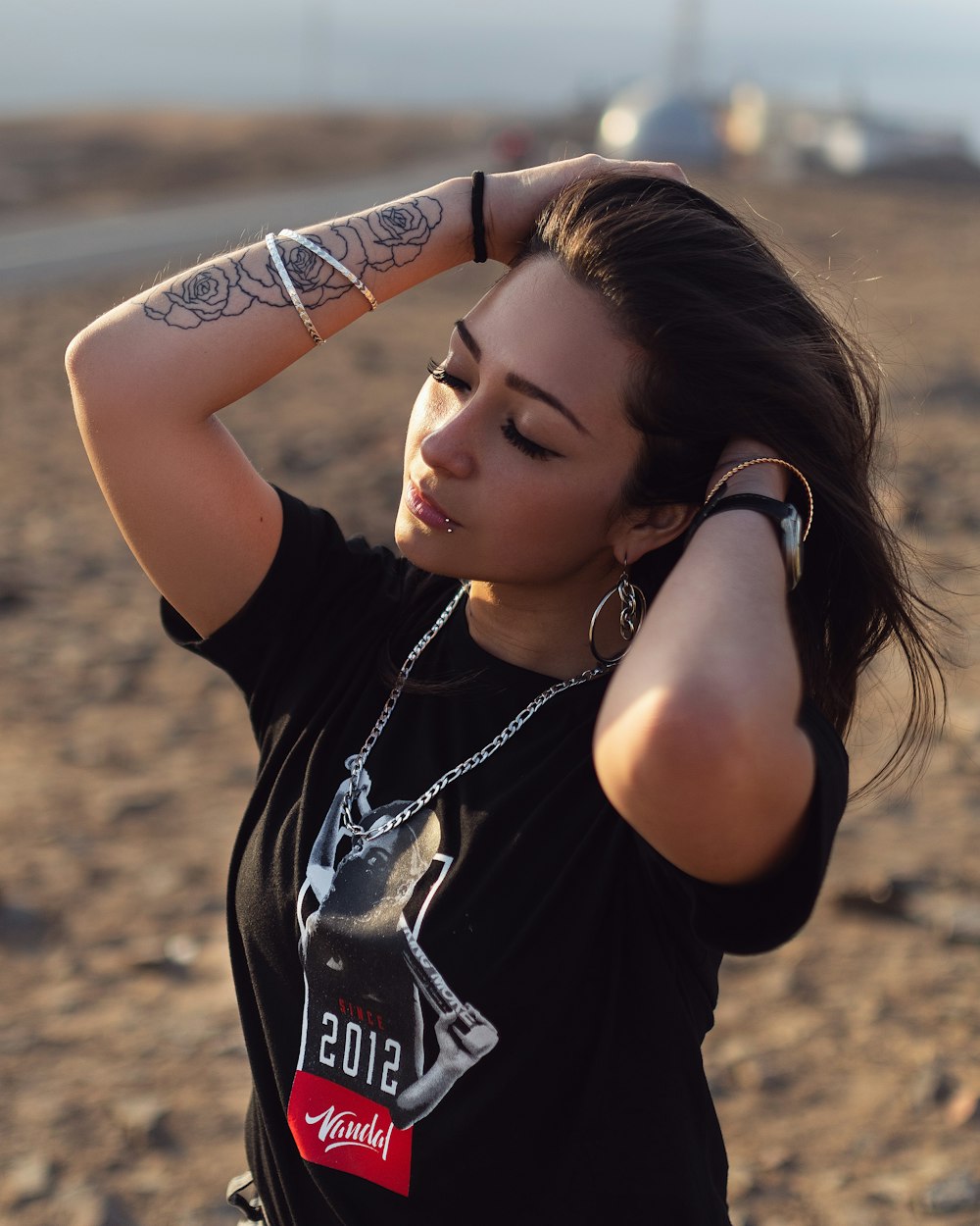 girl wearing black and white crew-neck t-shirt standing outdoor during daytime selective focus photography