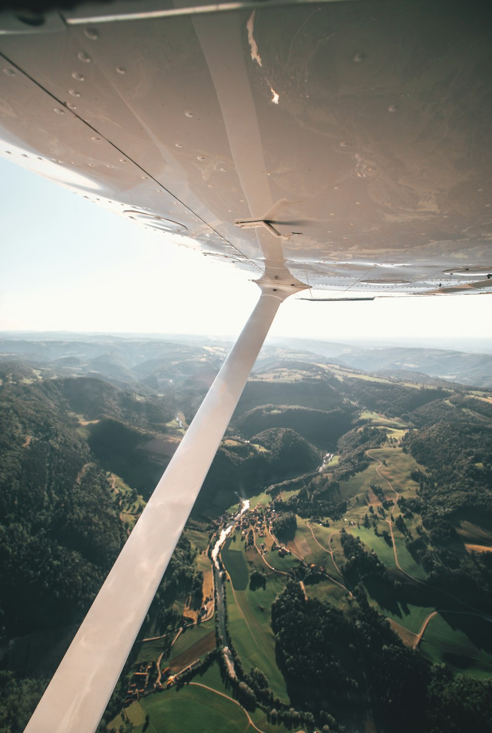 aerial photography of green field and mountain