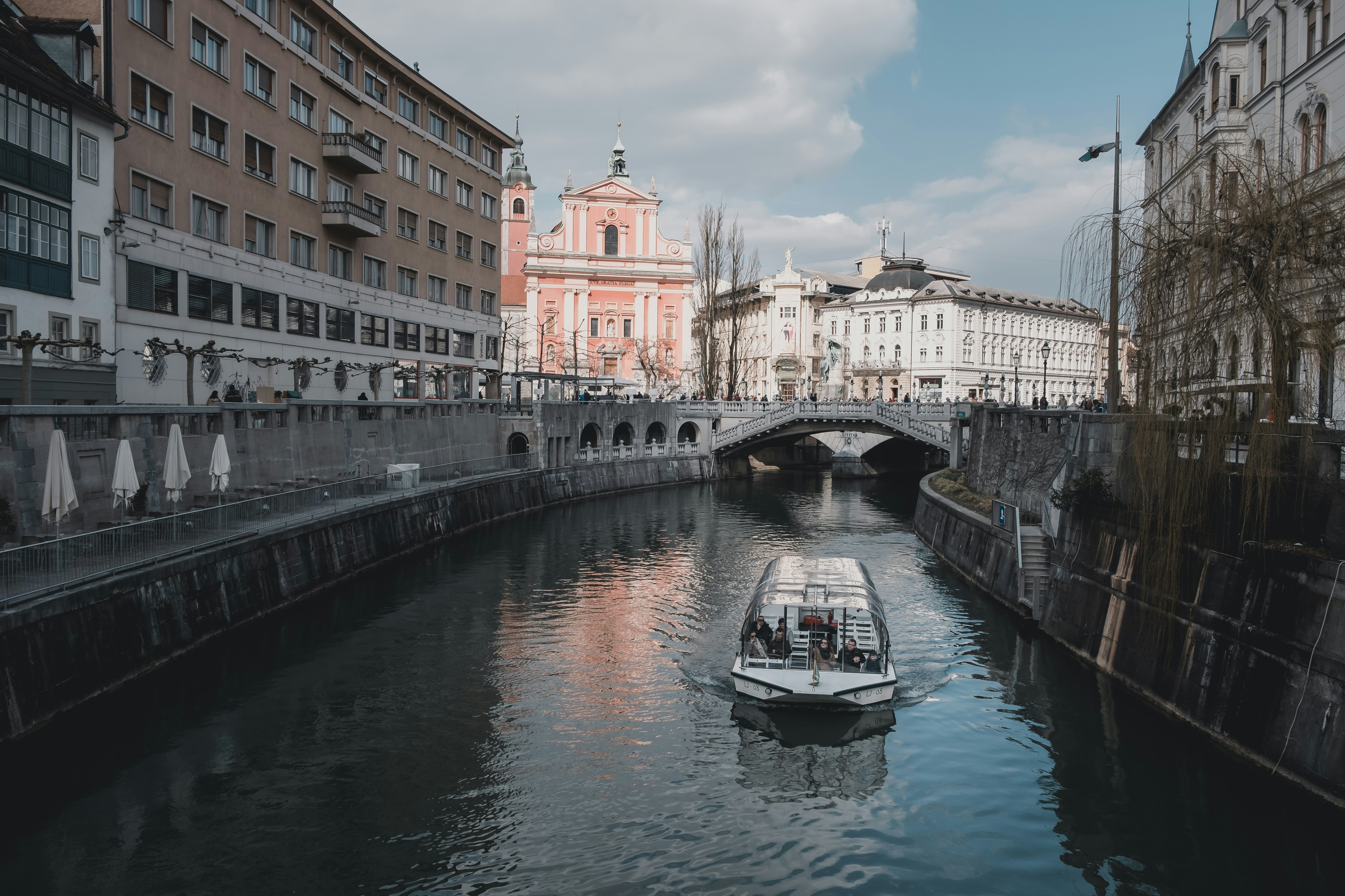 white boat on body of water, A canal boat tour in Ljubljana.</p><p>IG: instagram.com/febiyanr