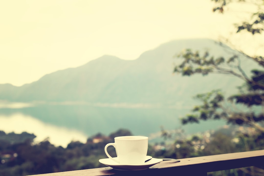 white ceramic mug on brown balcony