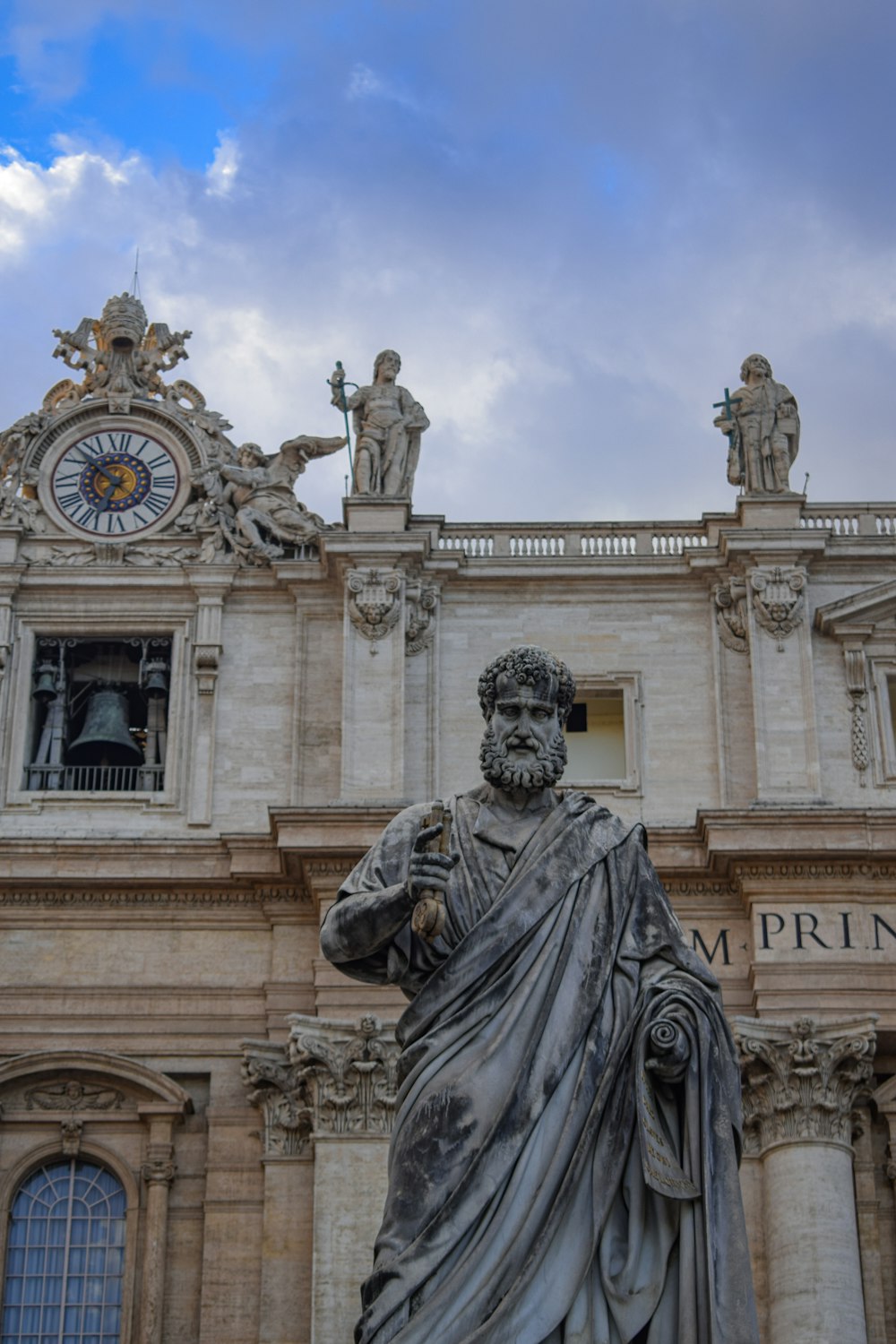 man holding weapon statue