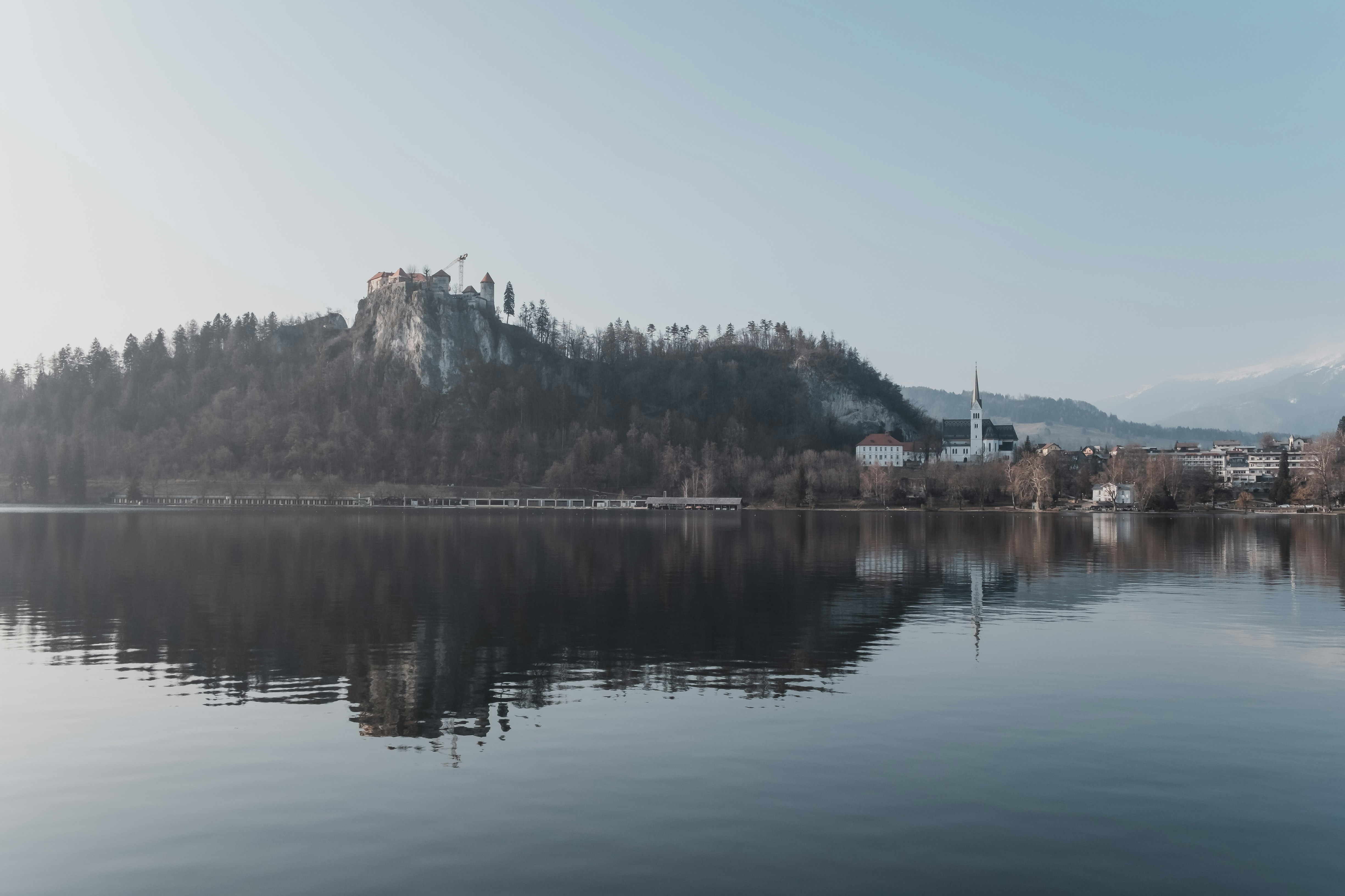 reflection of mountain on body of water during daytime