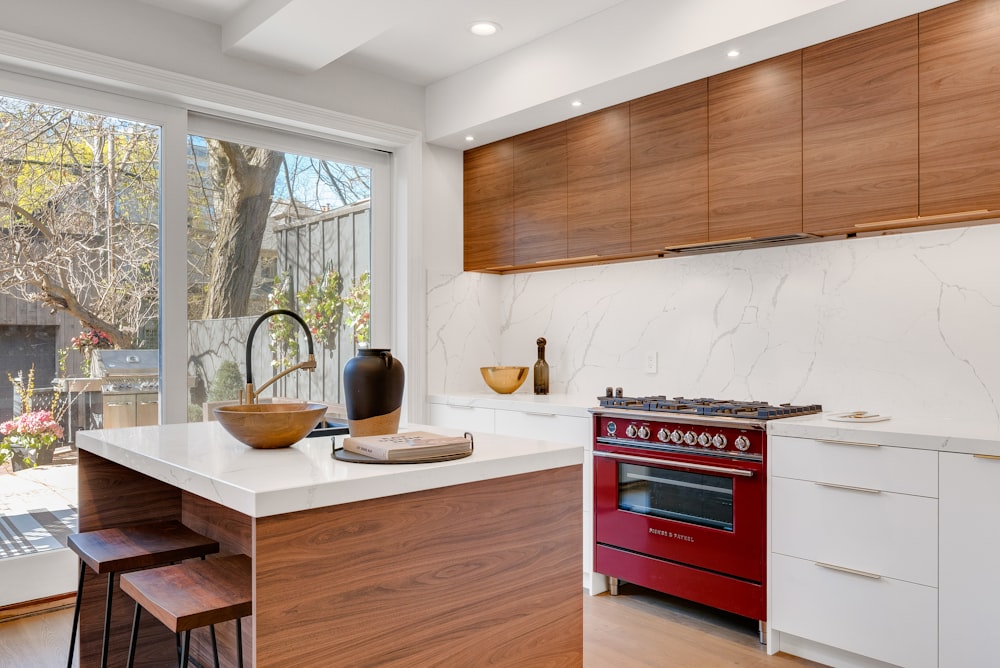 kitchen island near gas range beside base cabinets