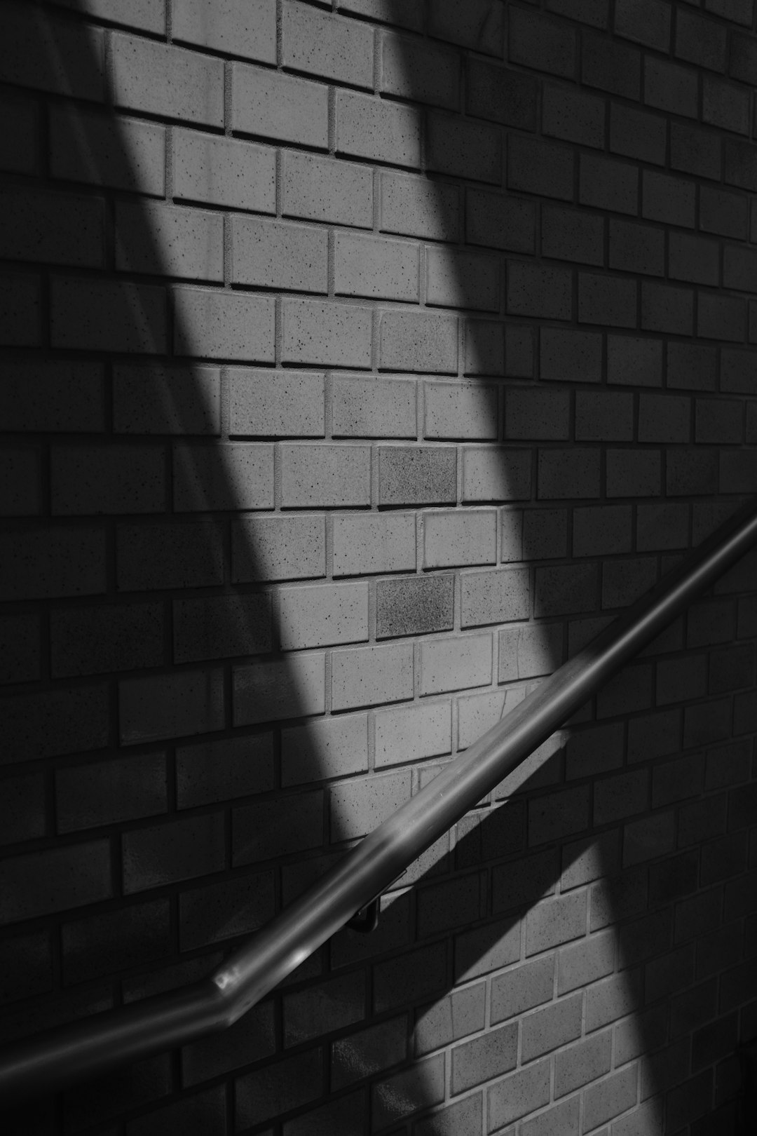 grayscale photo of stair rail