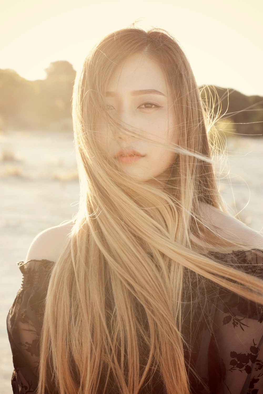 woman standing near trees during golden hour